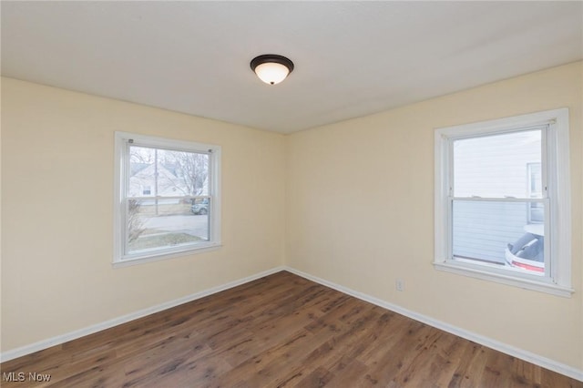 spare room featuring dark hardwood / wood-style floors