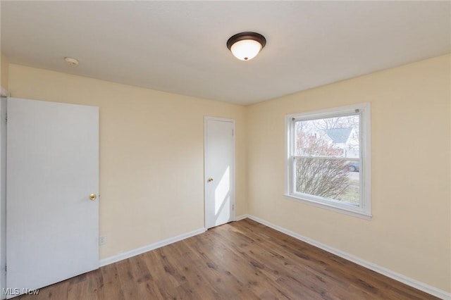 unfurnished room with hardwood / wood-style flooring