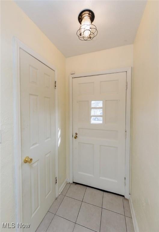 doorway to outside featuring light tile patterned flooring