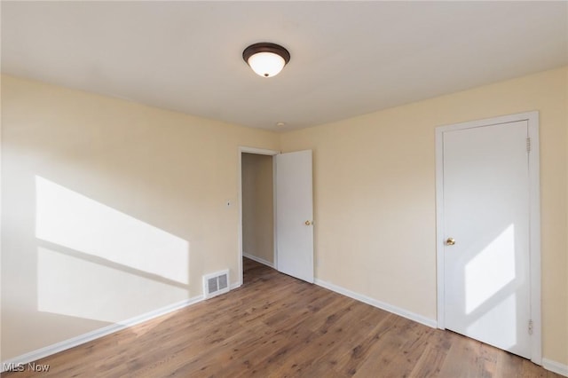 spare room featuring hardwood / wood-style floors