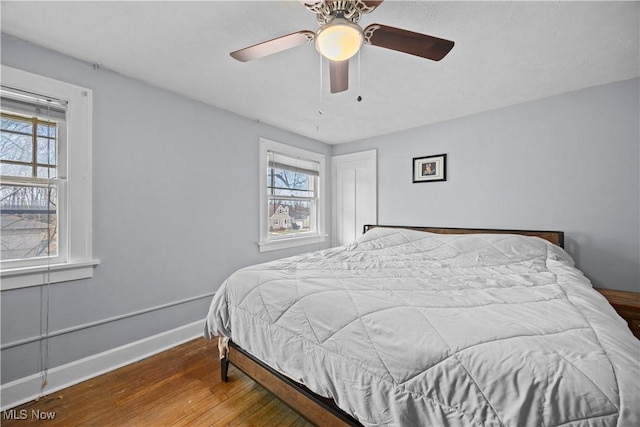 bedroom featuring hardwood / wood-style floors and ceiling fan