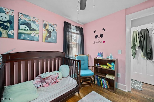 bedroom featuring dark hardwood / wood-style flooring and ceiling fan