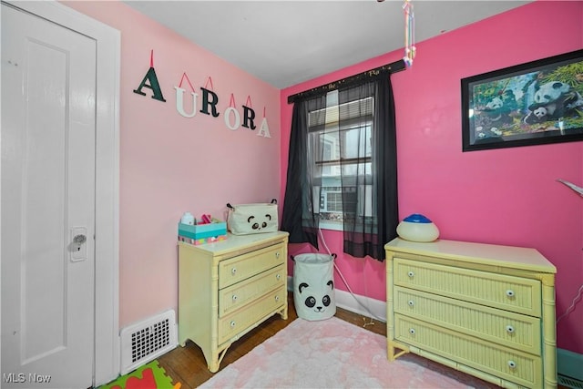 bedroom with hardwood / wood-style floors