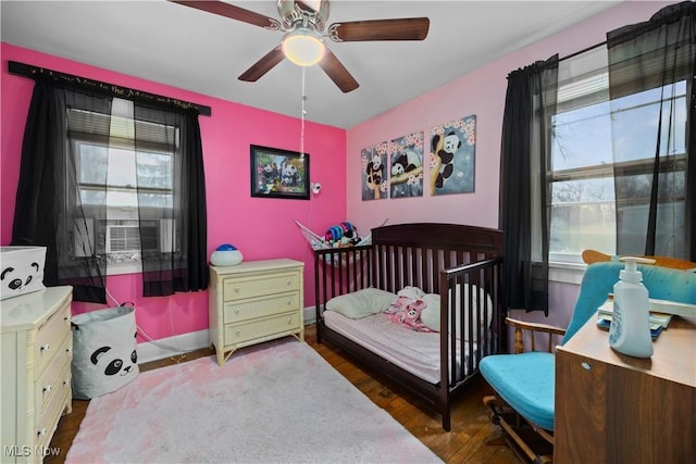 bedroom with dark wood-type flooring and ceiling fan