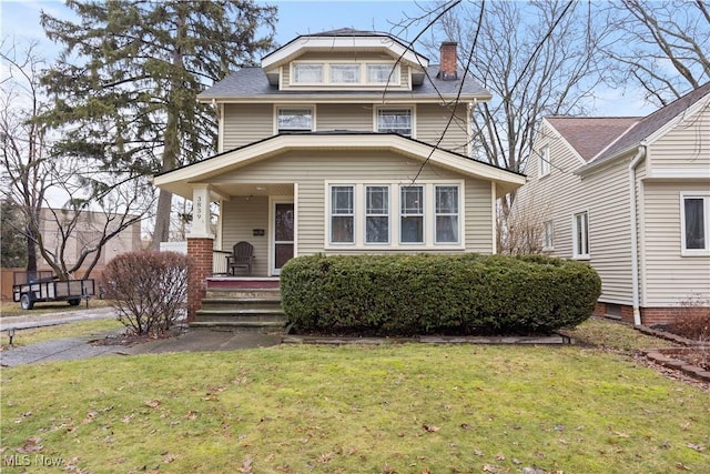 view of front facade with a front yard and covered porch