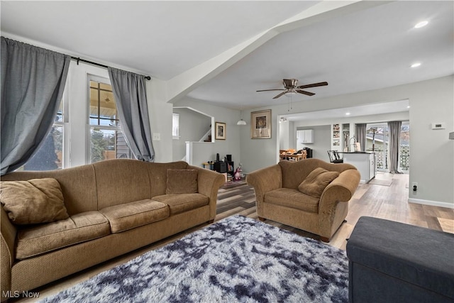 living room featuring ceiling fan and light hardwood / wood-style floors