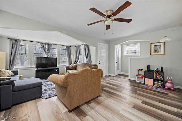 living room featuring hardwood / wood-style floors and ceiling fan