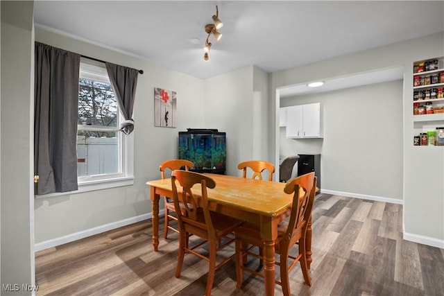 dining space with hardwood / wood-style flooring