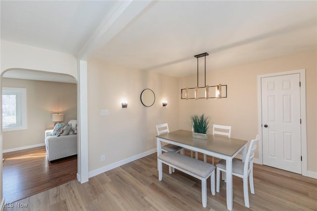 dining space featuring an inviting chandelier and light hardwood / wood-style flooring