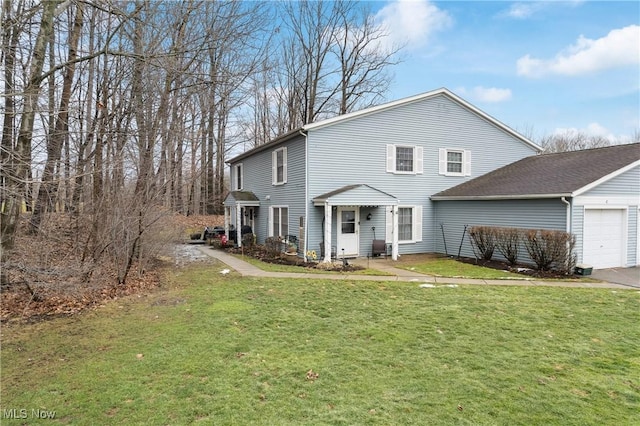 view of front of house with a garage and a front lawn