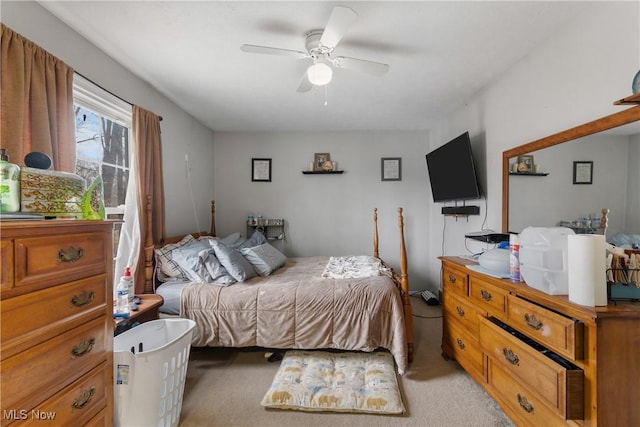 bedroom featuring light carpet and ceiling fan