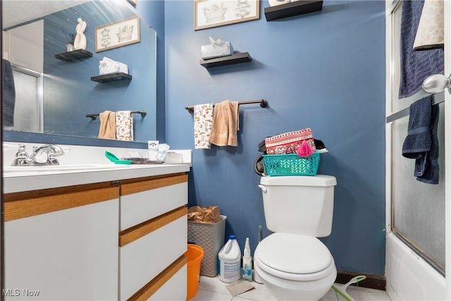 full bathroom featuring vanity, tile patterned floors, shower / bath combination with glass door, and toilet