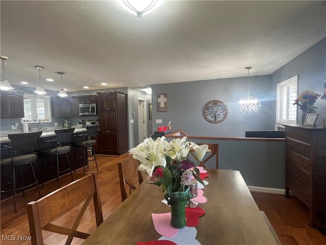 dining area featuring dark hardwood / wood-style floors and a notable chandelier