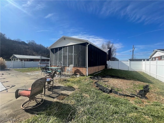 view of yard with a patio area and a sunroom