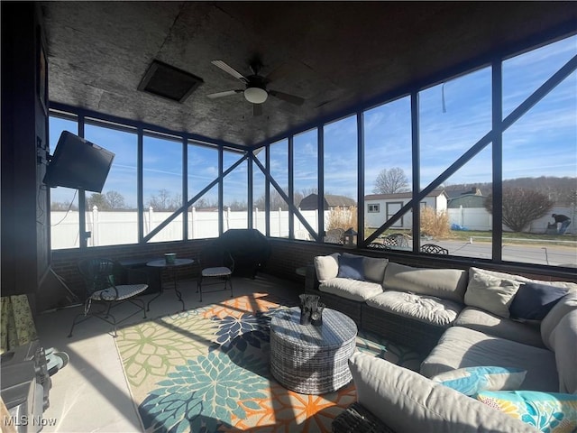 sunroom / solarium featuring ceiling fan