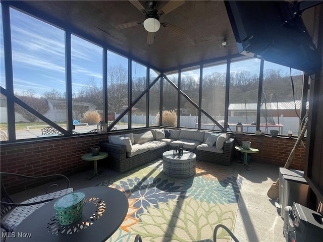 sunroom / solarium featuring ceiling fan