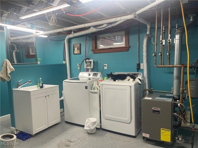 laundry room featuring sink and washer and dryer