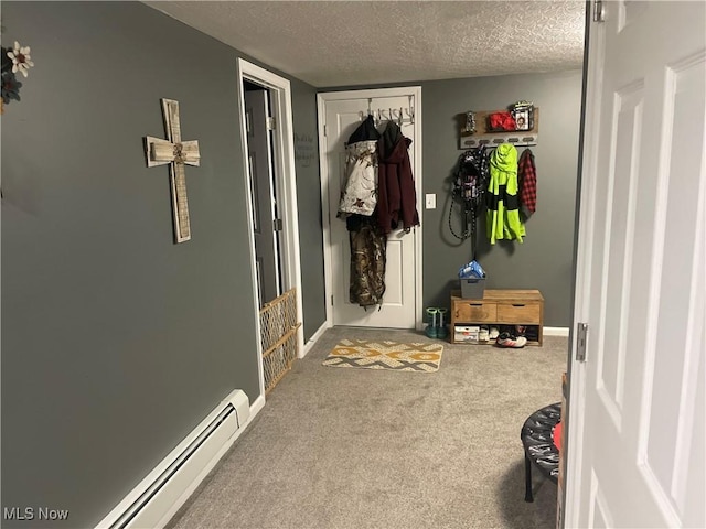 mudroom with carpet flooring, a textured ceiling, and baseboard heating