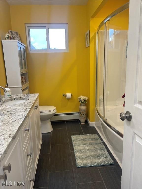 full bathroom with enclosed tub / shower combo, vanity, a baseboard heating unit, and toilet