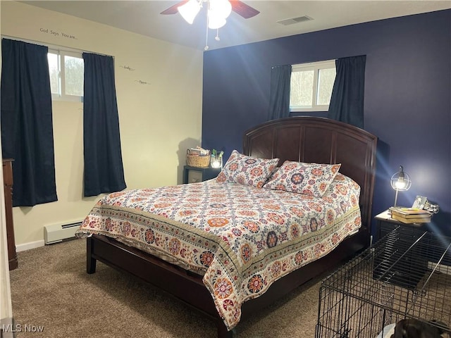 carpeted bedroom featuring ceiling fan, a baseboard radiator, and multiple windows