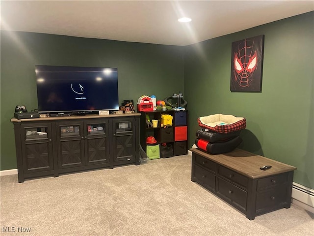 game room featuring light colored carpet and baseboard heating