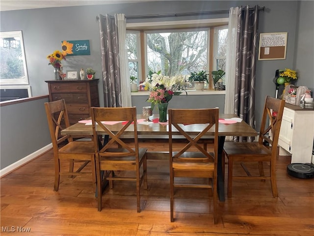 dining space with light hardwood / wood-style floors