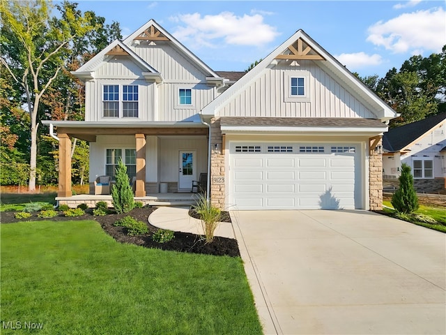 craftsman inspired home with a porch, a garage, and a front yard