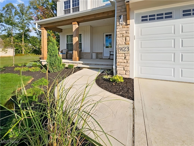 property entrance featuring a garage and covered porch