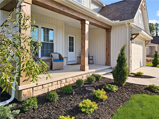 doorway to property featuring a garage and covered porch