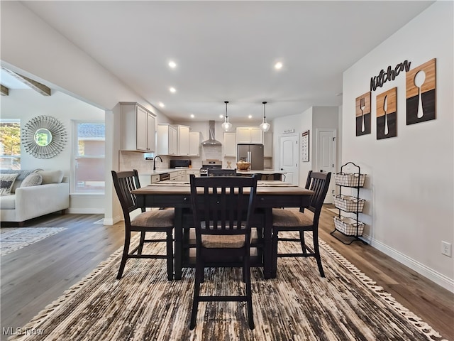 dining space featuring dark hardwood / wood-style floors and sink