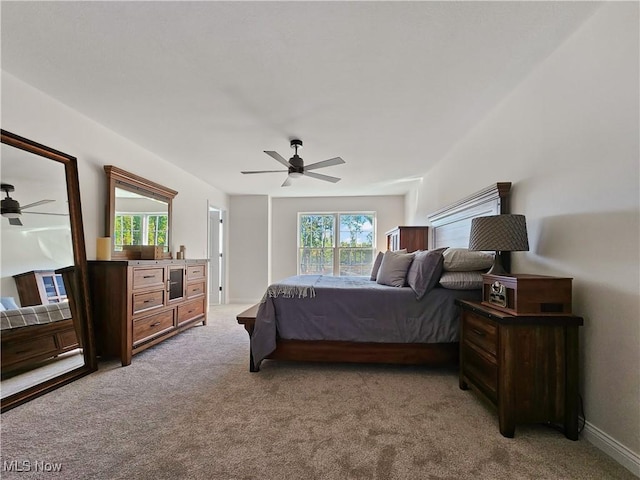 bedroom with ceiling fan and light carpet