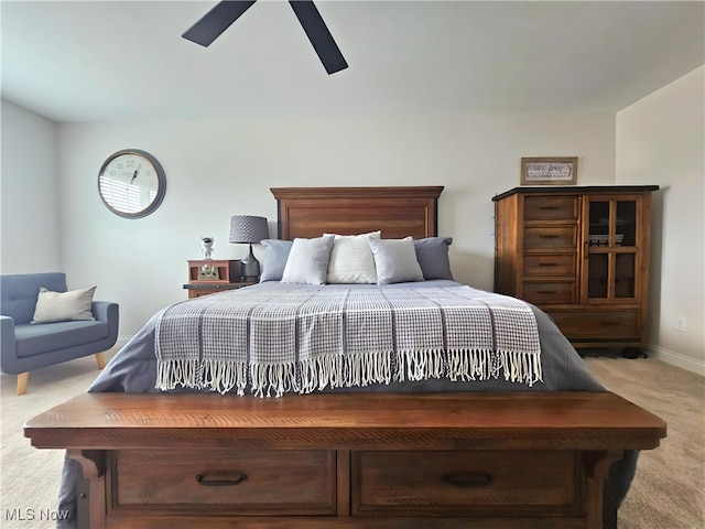 bedroom with light carpet and ceiling fan