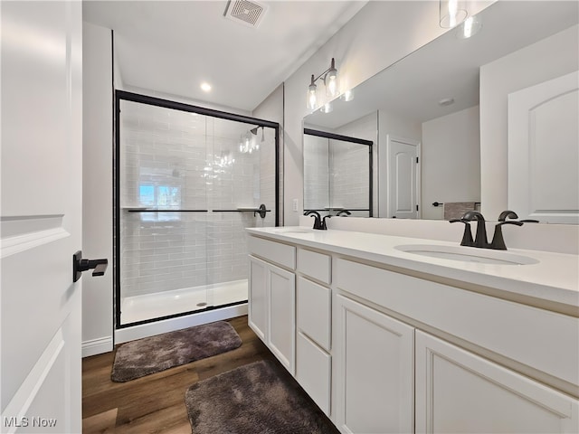 bathroom with vanity, hardwood / wood-style floors, and walk in shower