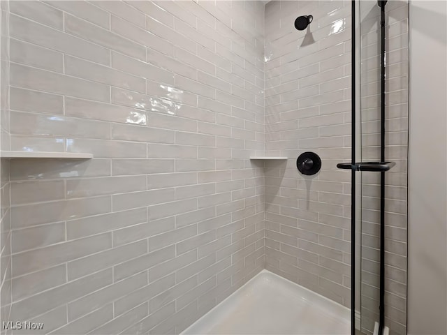 bathroom with tiled shower