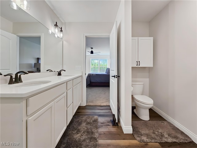 bathroom featuring vanity, wood-type flooring, and toilet