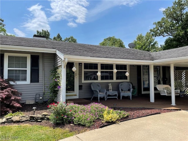 view of exterior entry with a porch