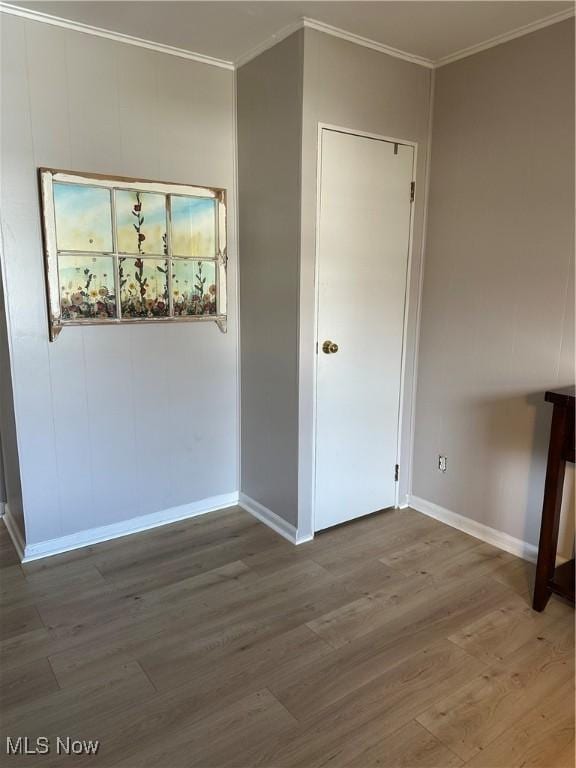 empty room featuring hardwood / wood-style floors and ornamental molding