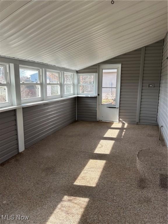 unfurnished sunroom featuring lofted ceiling and a wealth of natural light