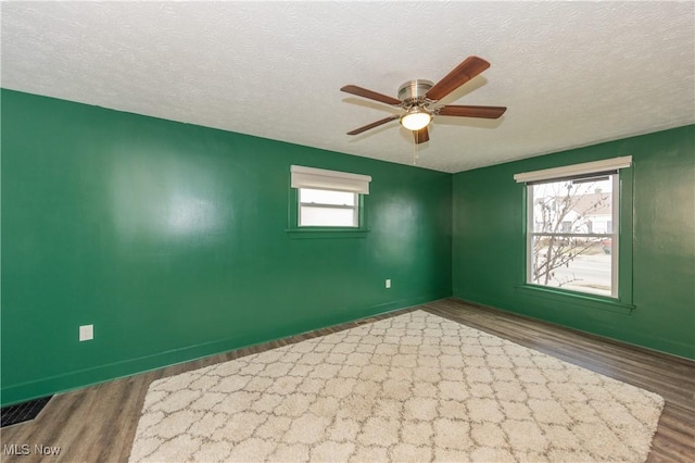 spare room featuring hardwood / wood-style floors, a textured ceiling, and ceiling fan