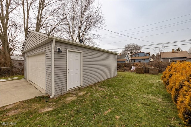 view of outdoor structure with a garage and a lawn