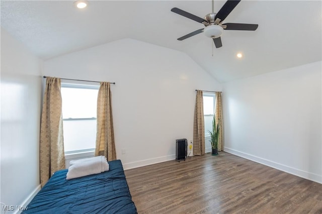 unfurnished bedroom with vaulted ceiling, dark hardwood / wood-style floors, and ceiling fan