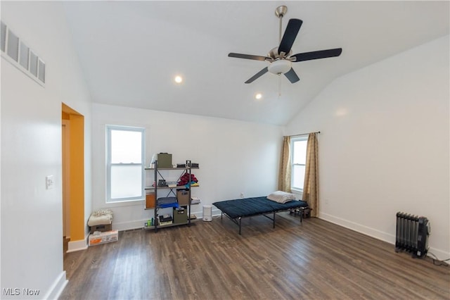 interior space featuring dark hardwood / wood-style flooring, radiator, high vaulted ceiling, and ceiling fan