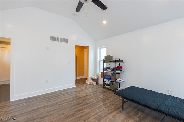 bedroom with dark wood-type flooring, ceiling fan, and high vaulted ceiling