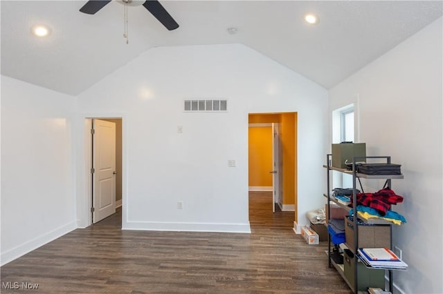 unfurnished bedroom with lofted ceiling, dark wood-type flooring, and ceiling fan