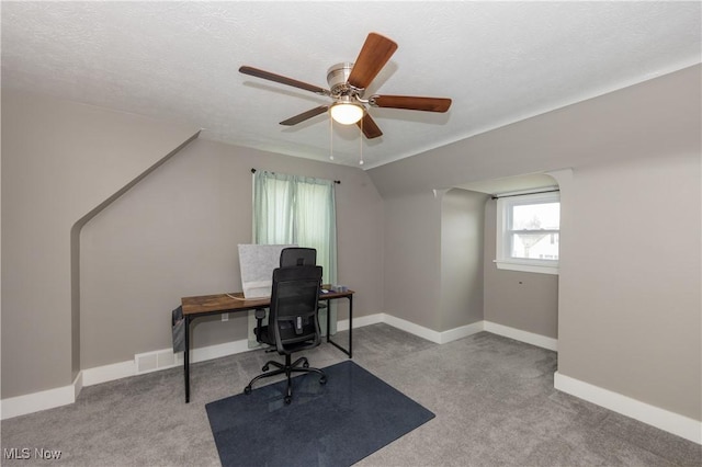 office area with light carpet, ceiling fan, lofted ceiling, and a textured ceiling