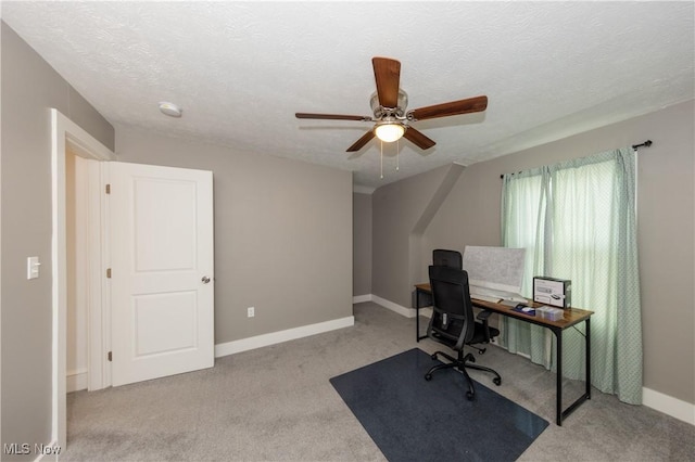 carpeted home office with a textured ceiling