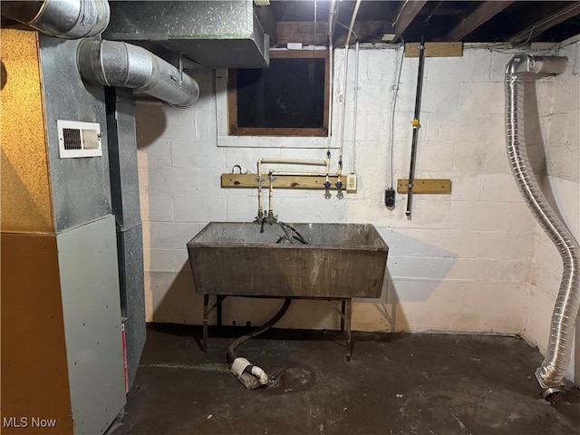 basement with sink and heating unit