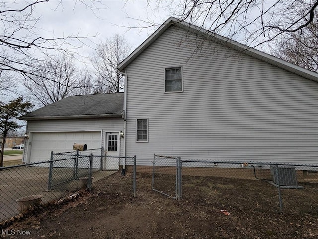 view of home's exterior featuring a garage and central air condition unit