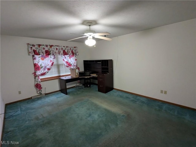 office space with ceiling fan and dark colored carpet