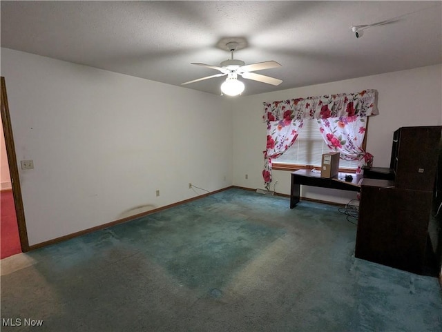 interior space with dark carpet and ceiling fan